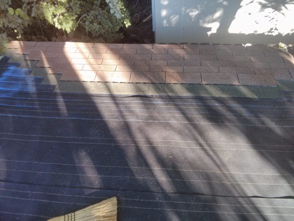 The first set of rows of shingles with the chalk lines to make sure they are straight and spaced correctly.